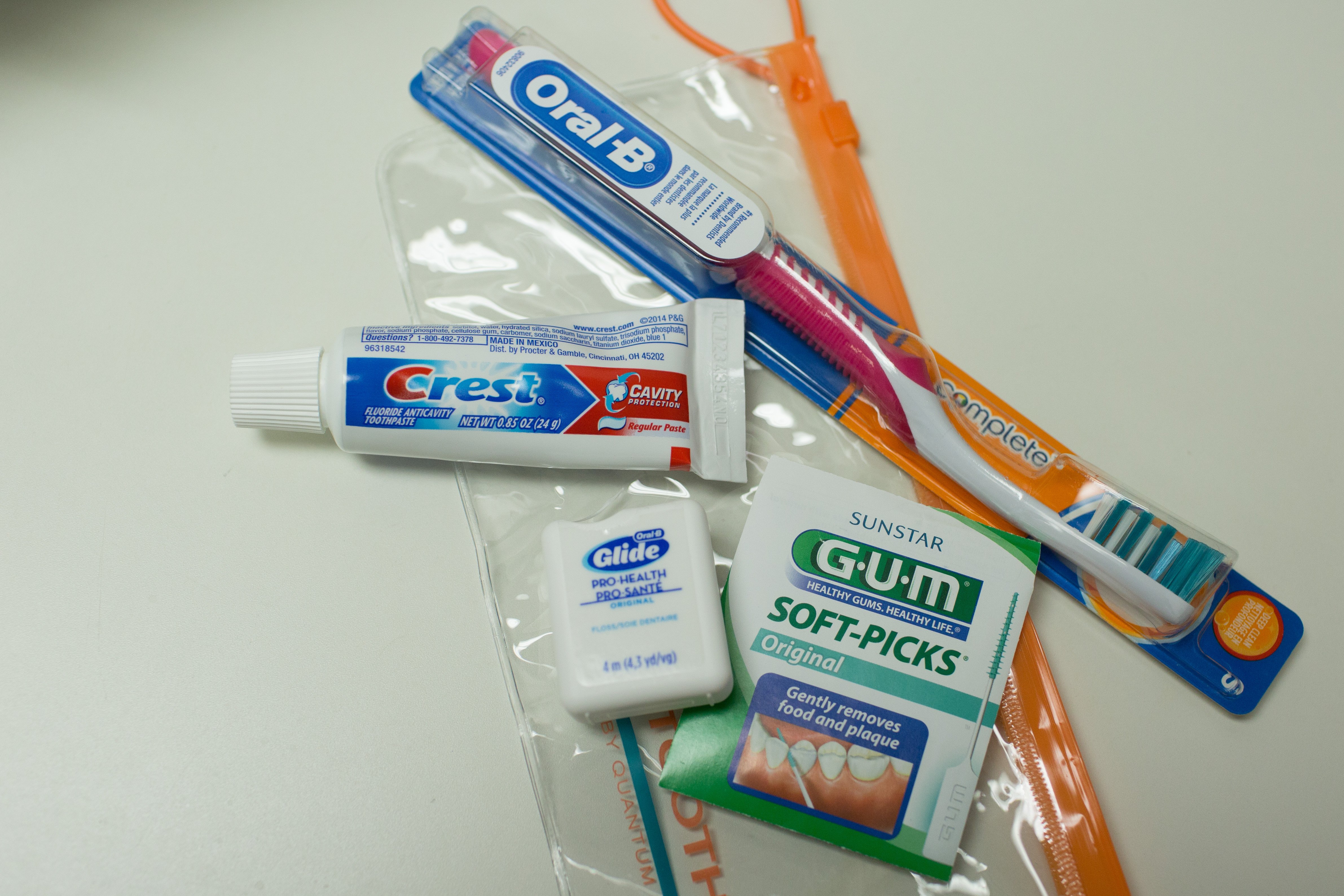 Dental care package of Oral-B brush, Crest Toothpaste, Glide Floss, Sunstar Gum soft-picks